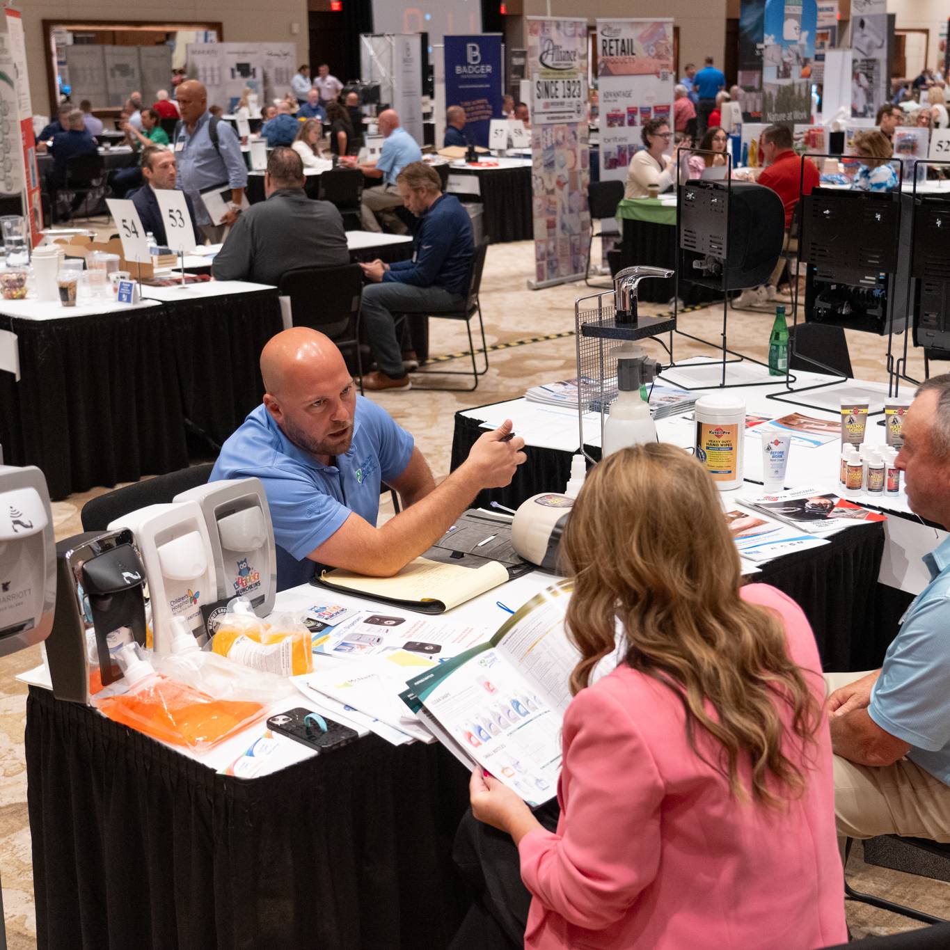 people talking at a supplier table