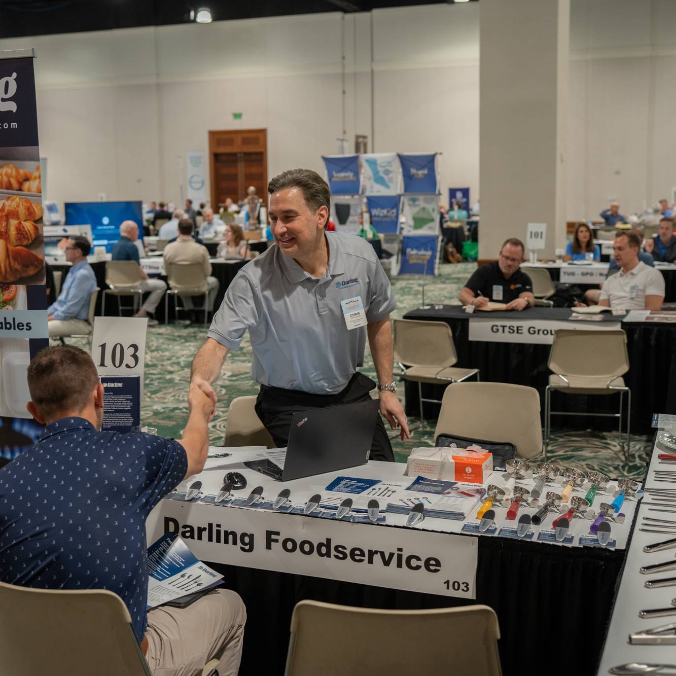 two business men shaking hands at conference