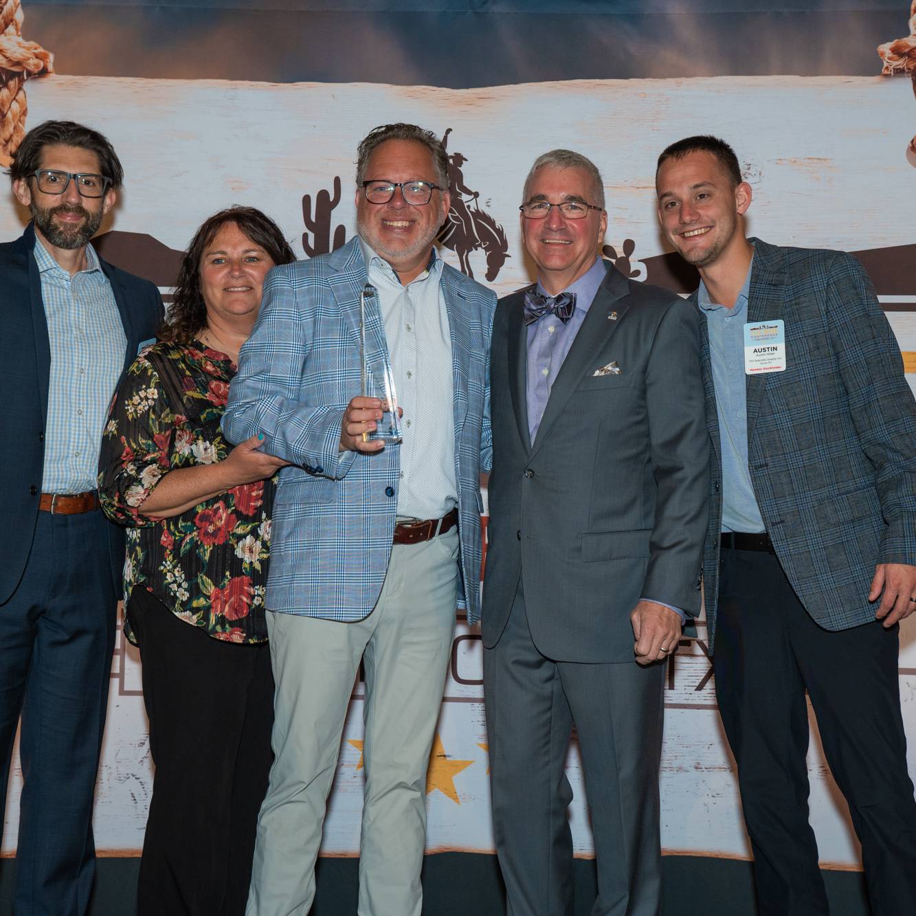 people grouped around award