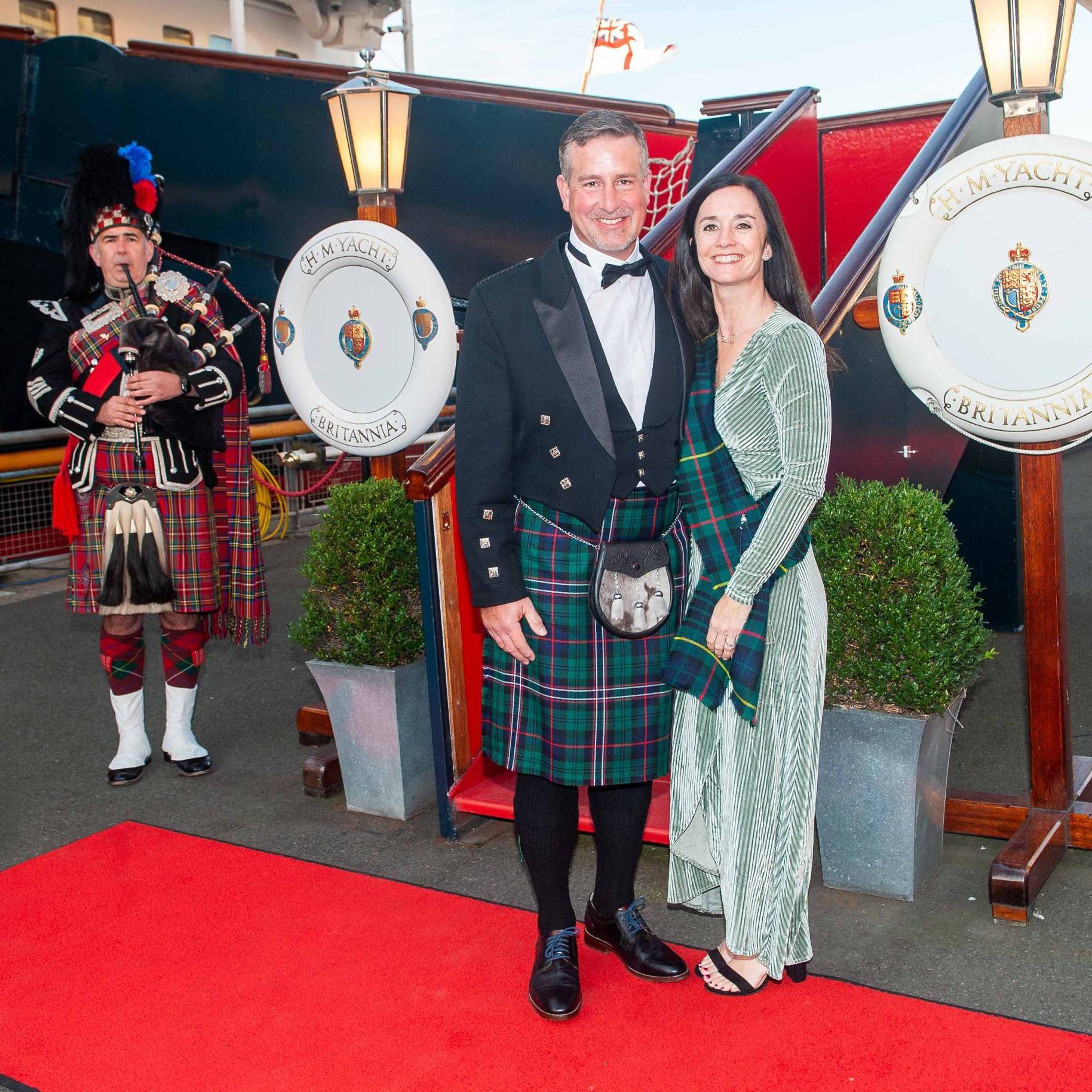 man and woman dressed on red carpet