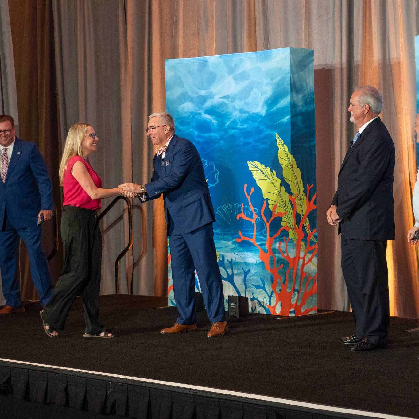 man shaking woman's hand