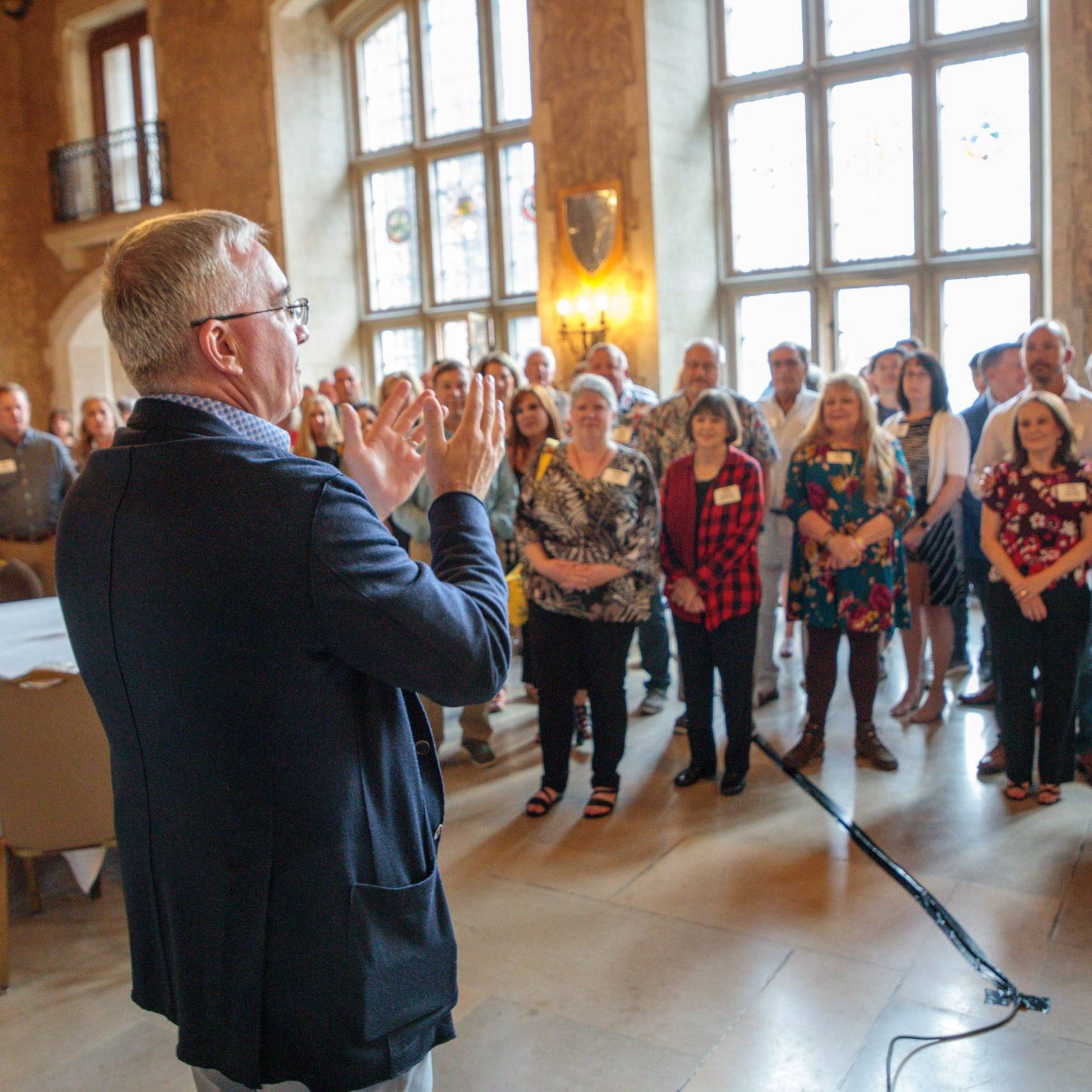 man talking to small crowd