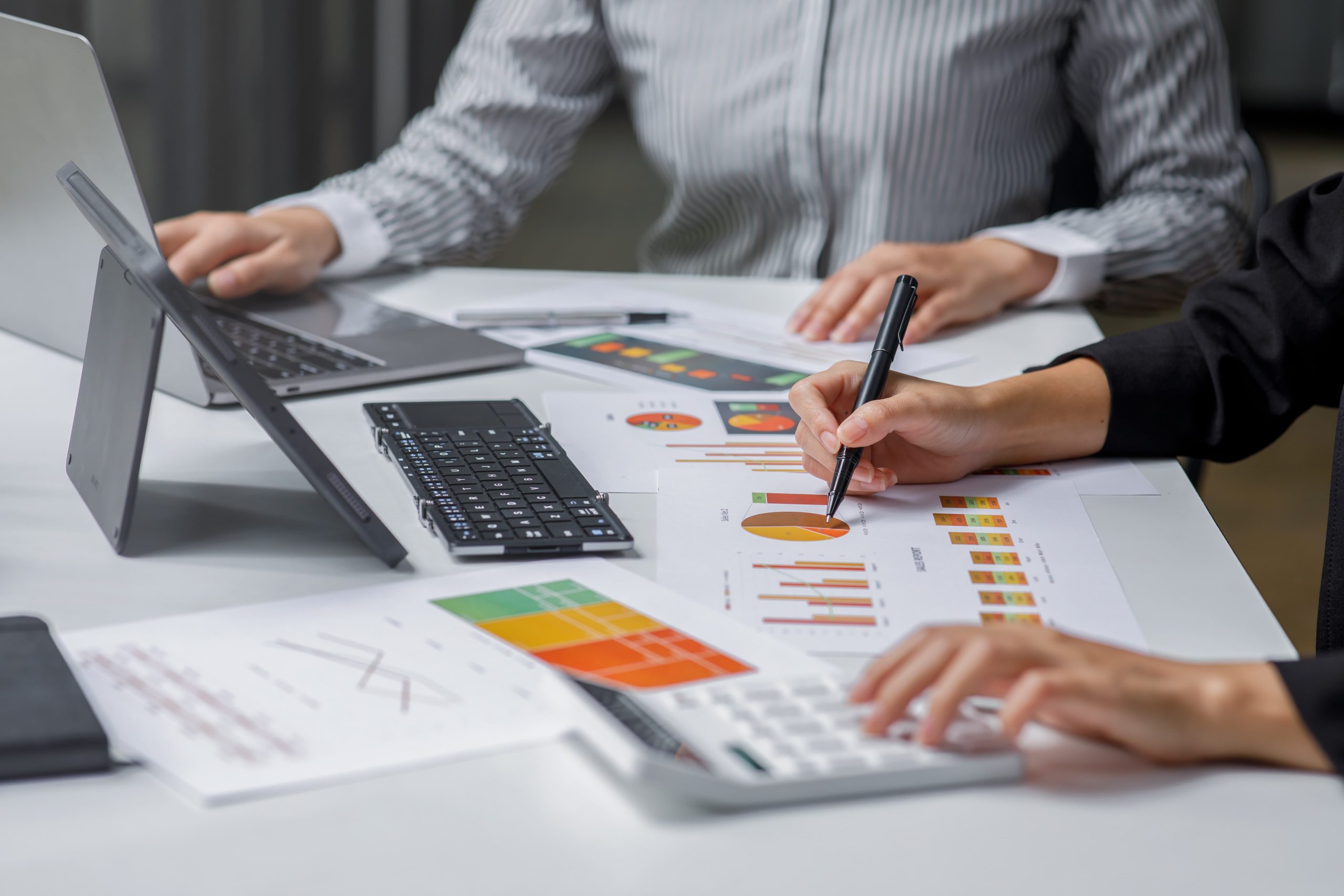 people analyzing business data charts